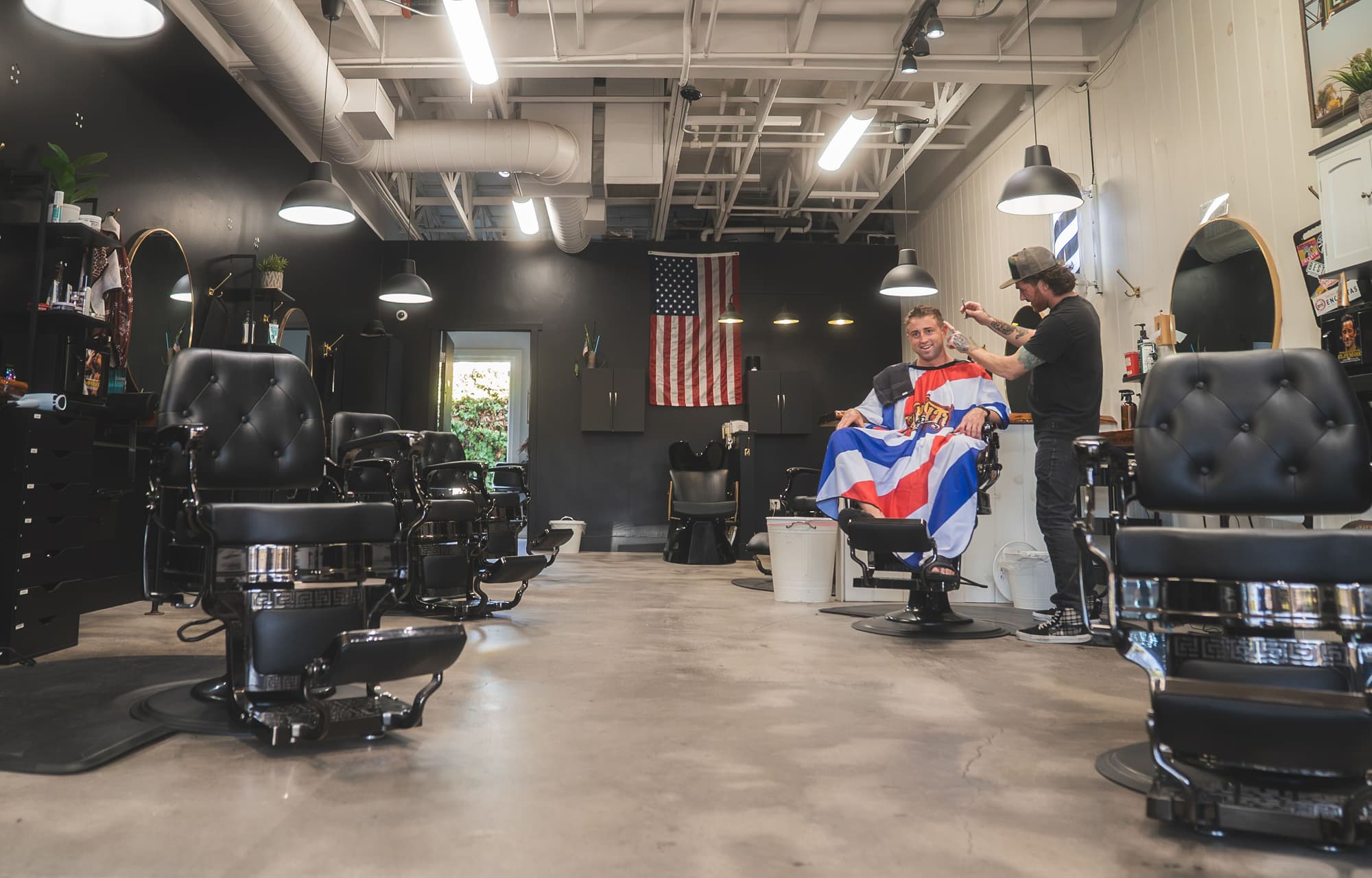 Barber Refinery shop floor with black leather chairs